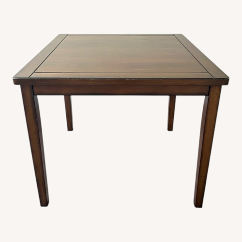 Used Raymour & Flanigan Dark Brown Wood Dining Table for sale on AptDeco