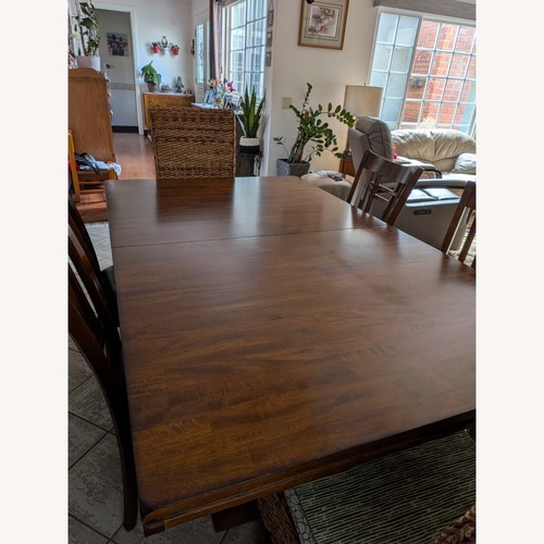 Used Dark Brown Wood Dining Table for sale on AptDeco