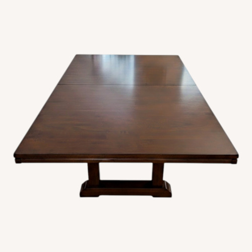 Used Dark Brown Wood Dining Table for sale on AptDeco