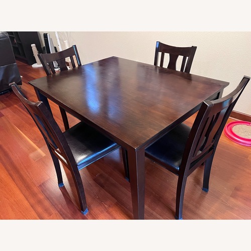 Used Dark Brown Wood Veneer Dining Table for sale on AptDeco