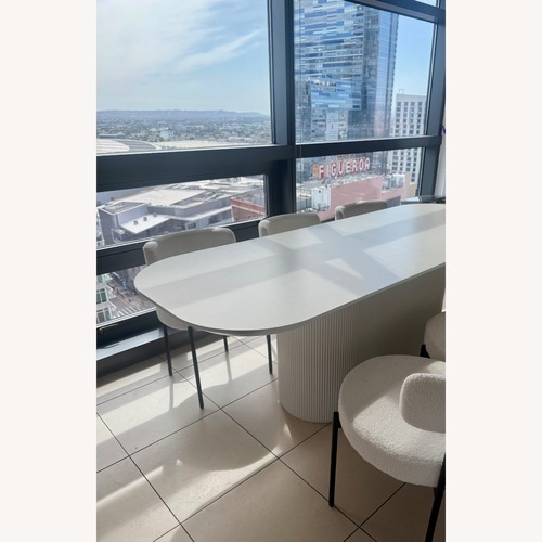 Used White Fluted Oval Dining Set W 6 Chairs for sale on AptDeco