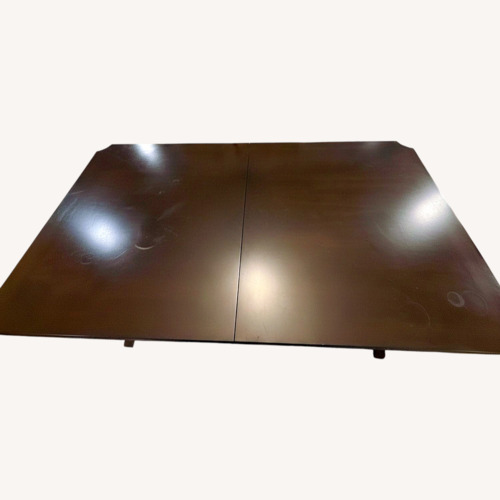 Used Raymour & Flanigan Dark Brown Wood Dining Table for sale on AptDeco