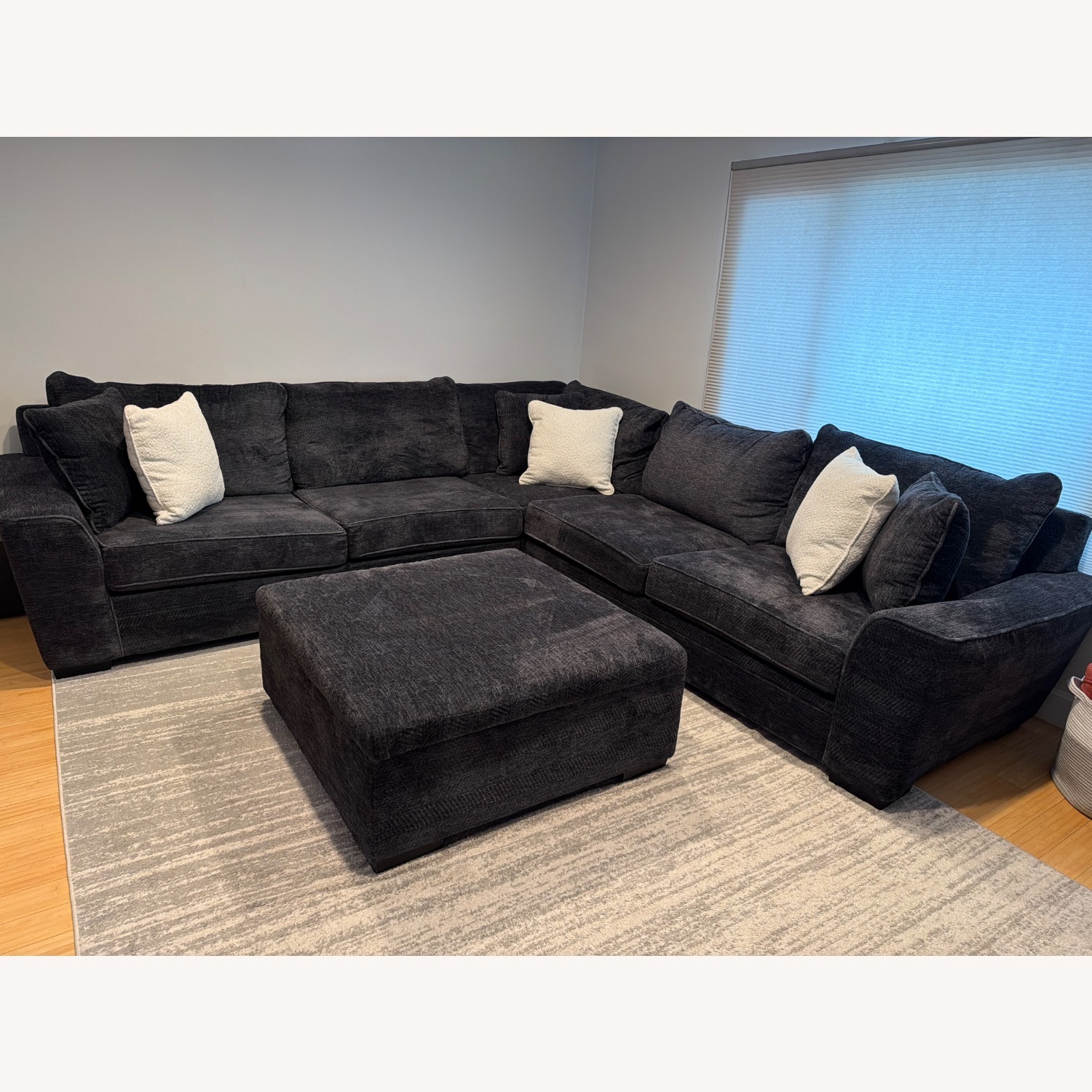 Living Spaces Dark Gray Sectional and Ottoman - image-1