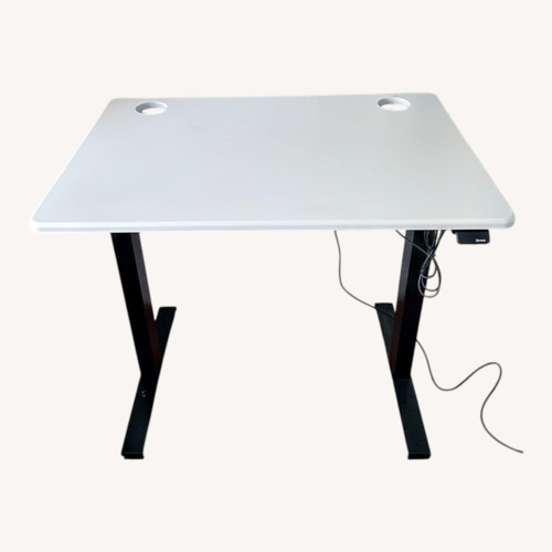 Used Black and White Motorized Standing Desk for sale on AptDeco