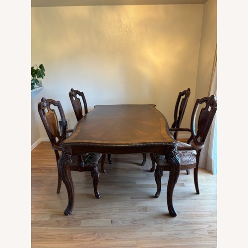 Used Carved Dark Wood Dining Set with 8 Chairs for sale on AptDeco