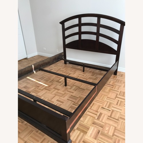 Used Raymour & Flanigan Dark Brown Wood Queen Bed for sale on AptDeco