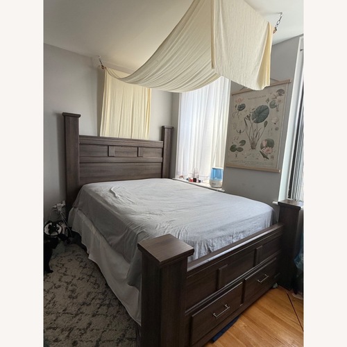 Used Ashley Furniture Juraro Dark Brown Queen Poster Bed for sale on AptDeco