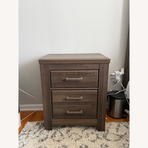 Used Ashley Furniture Juararo Dark Brown Wood Nightstand for sale on AptDeco
