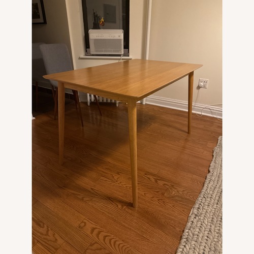 Used Amazon Natural Wood Veneer Dining Table for sale on AptDeco