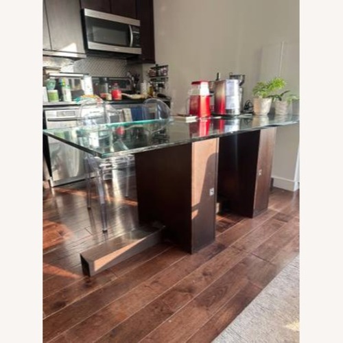 Used Dark Brown Glass Dining Table for sale on AptDeco