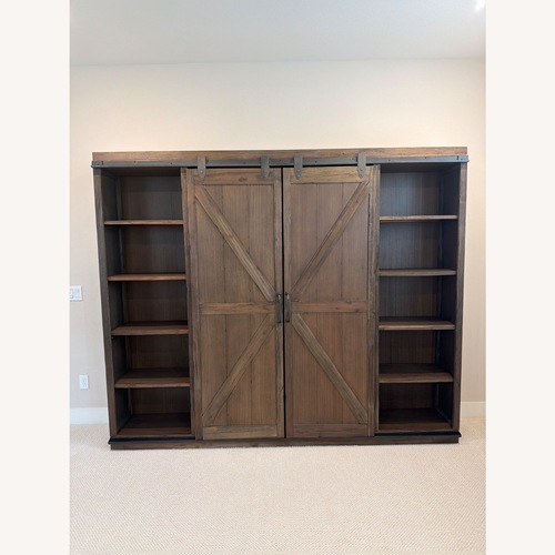 Used Large Burnt Alder Farmhouse Barn Door Bookshelf for sale on AptDeco