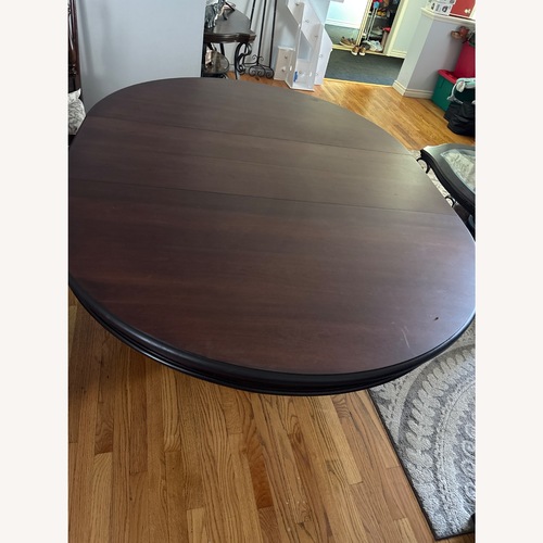 Used Dark Brown Wood Dining Table for sale on AptDeco