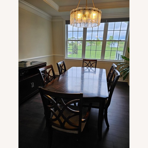 Used Dark Brown Wood Dining Table for sale on AptDeco