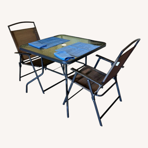 Used Glass Outdoor Dining Table and 4 Chairs for sale on AptDeco