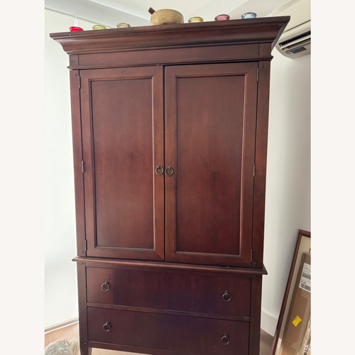 Used Dark Brown Wood Armoire for sale on AptDeco