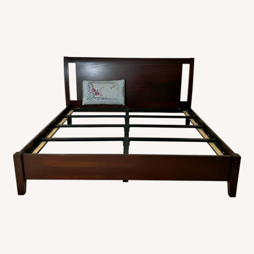 Used Living Spaces Dark Brown Wood King Bed for sale on AptDeco