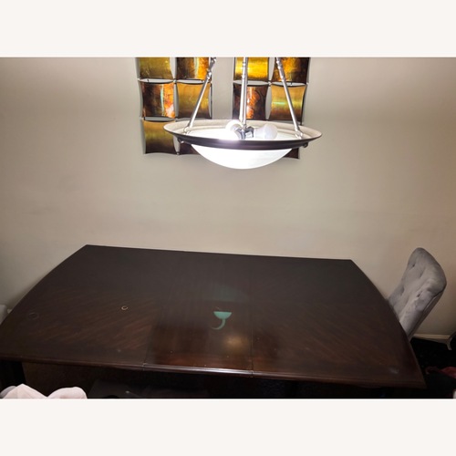 Used Ashley Furniture Dark Brown Wood Dining Table for sale on AptDeco