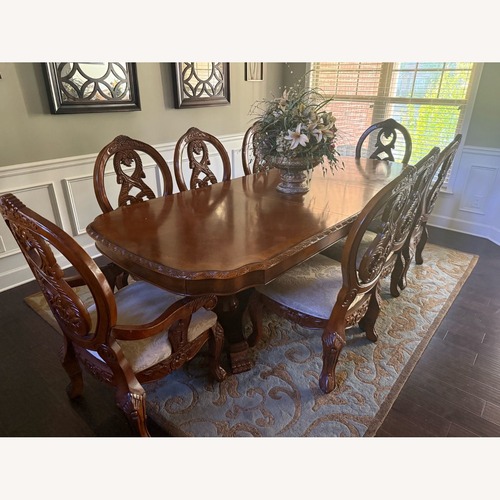 Used Ashley Furniture Dark Brown Wood Dining Table for sale on AptDeco