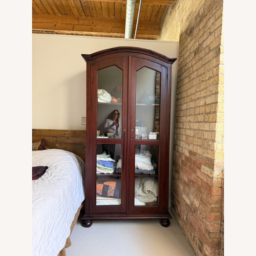 Used Dark Brown Wood Armoire for sale on AptDeco