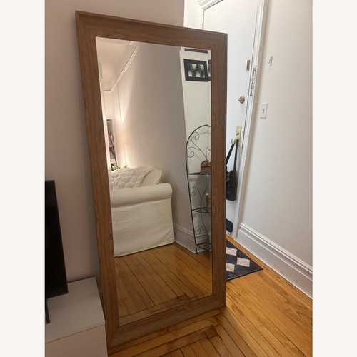 Used Home Goods Light Brown Wood Floor Mirror for sale on AptDeco