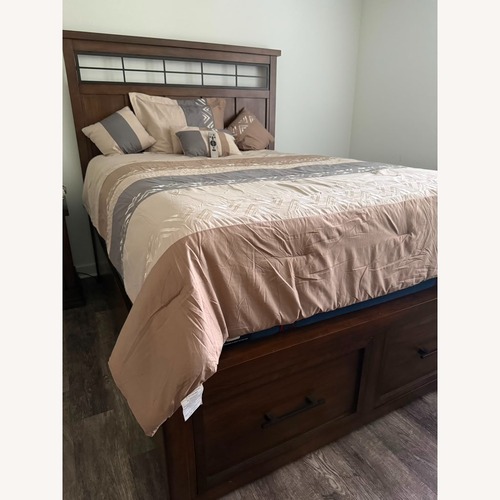 Used Ashley Taffenbrook Dark Brown Wood Queen Bed for sale on AptDeco
