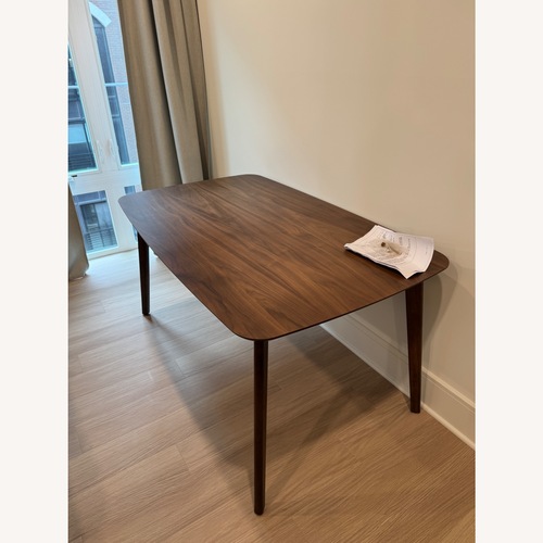 Used Dark Brown Wood Dining Table for sale on AptDeco
