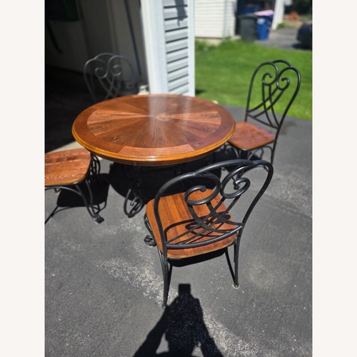 Used Dark Brown Wood Dining Table for sale on AptDeco