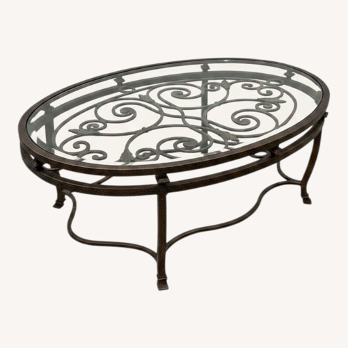 Used Iron Scrollwork Base Oval Glass Top Coffee Table for sale on AptDeco