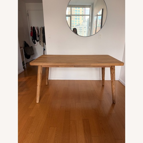 Used Castlery Light Brown Wood Dining Table for sale on AptDeco