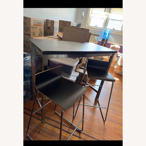Used Black Wood Dining Table for sale on AptDeco
