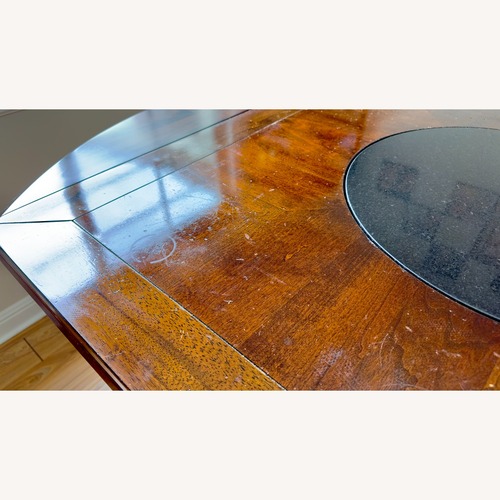 Used Dark Brown Wood Dining Table for sale on AptDeco