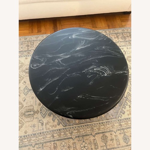 Used CB2 Espira 35" Round Black Marbled Resin Coffee Table for sale on AptDeco