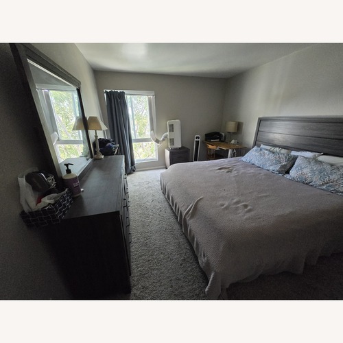 Used Black Wood King Bed for sale on AptDeco