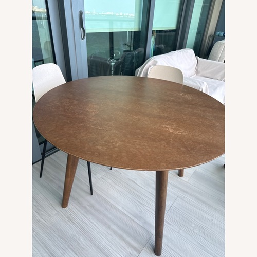 Used Article Walnut Rounded Dining Table for sale on AptDeco