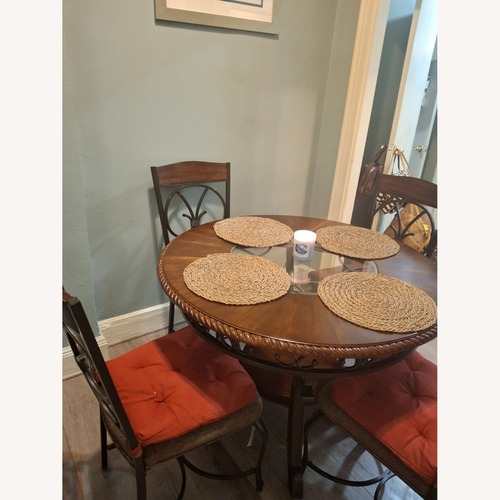 Used Ashley Furniture Dark Brown Wood Dining Table for sale on AptDeco