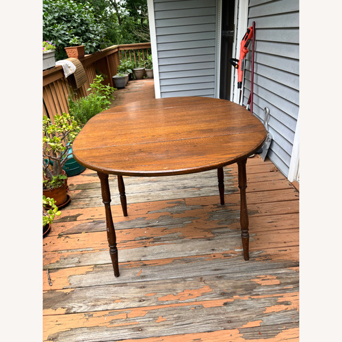 Used Oak Oval Dining Table w Folding Side Leaves for sale on AptDeco