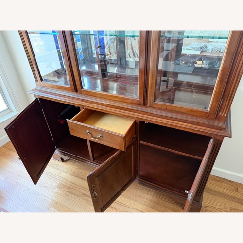 Used Ethan Allen china cabinet with glass doors for sale on AptDeco