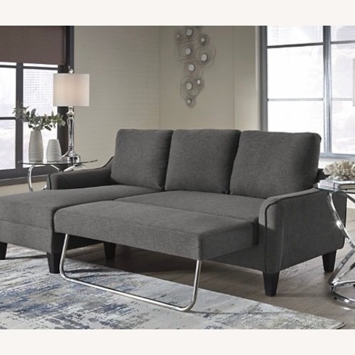 Used Ashley Furniture Jarreau Gray Sofa Chaise Sleeper for sale on AptDeco