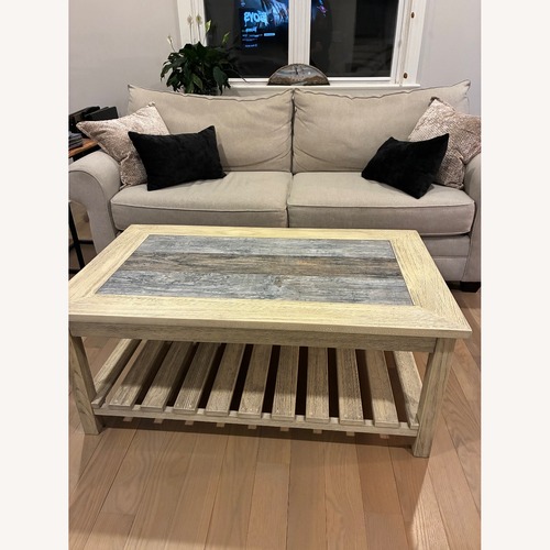 Used Ashley Distressed Grey & Cream Wood Coffee Table for sale on AptDeco