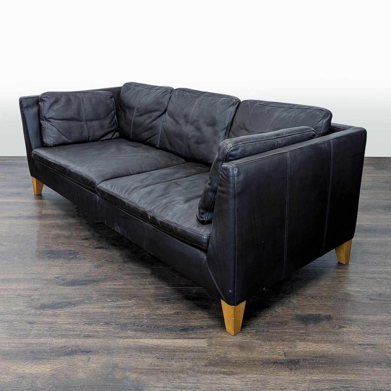 IKEA 3-Seat Dark Leather Sofa with Wooden Legs - image-1