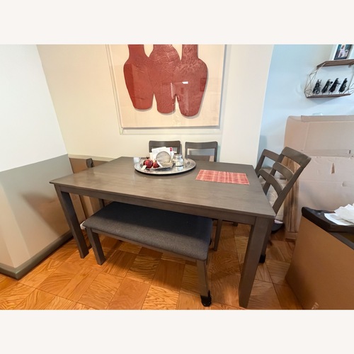 Used Ashley Signature Design Gray Wood 6 Person Dining Table Chairs and Bench for sale on AptDeco