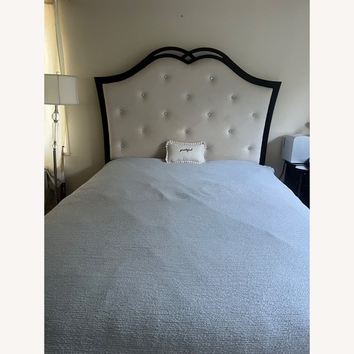 Used Raymour & Flanigan Dark Brown Wood Queen Bed for sale on AptDeco