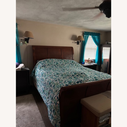 Used Dark Brown Wood Queen Bed for sale on AptDeco