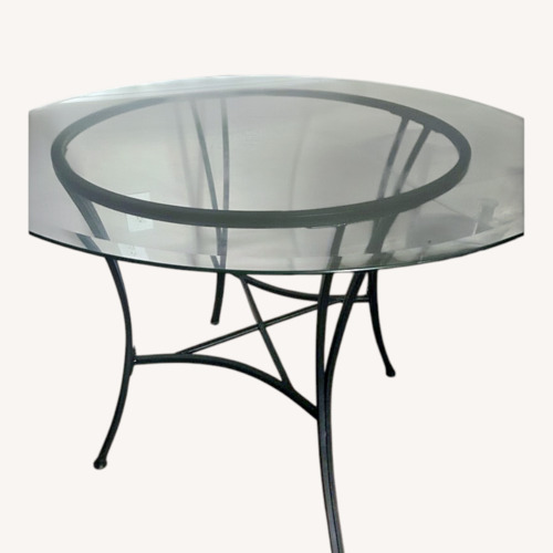 Used  Glass Dining Table with Black Metal Base for sale on AptDeco