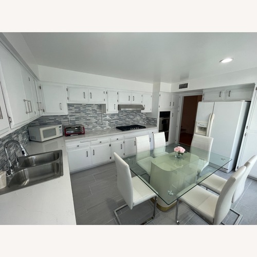 Used White Leather Dining Chairs & Glass Table for sale on AptDeco