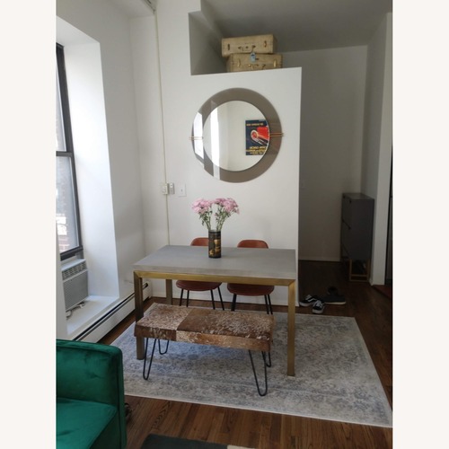 Used Crate & Barrel Gold Concrete Dining Table for sale on AptDeco