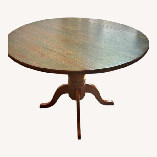 Used Honey Brown Drop Leaf Circle Dining Table for sale on AptDeco