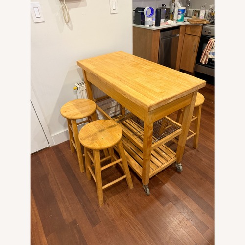 Used Wooden Dining Room Set with Stools for sale on AptDeco