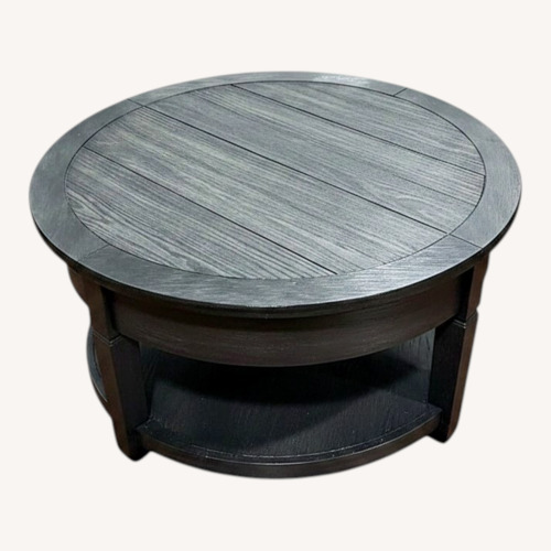 Used Round Black Wood Coffee Table for sale on AptDeco