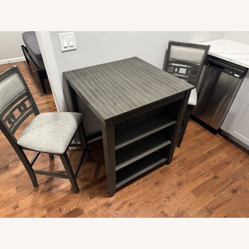 Used Dark Gray Wood Dining Table with Chairs for sale on AptDeco